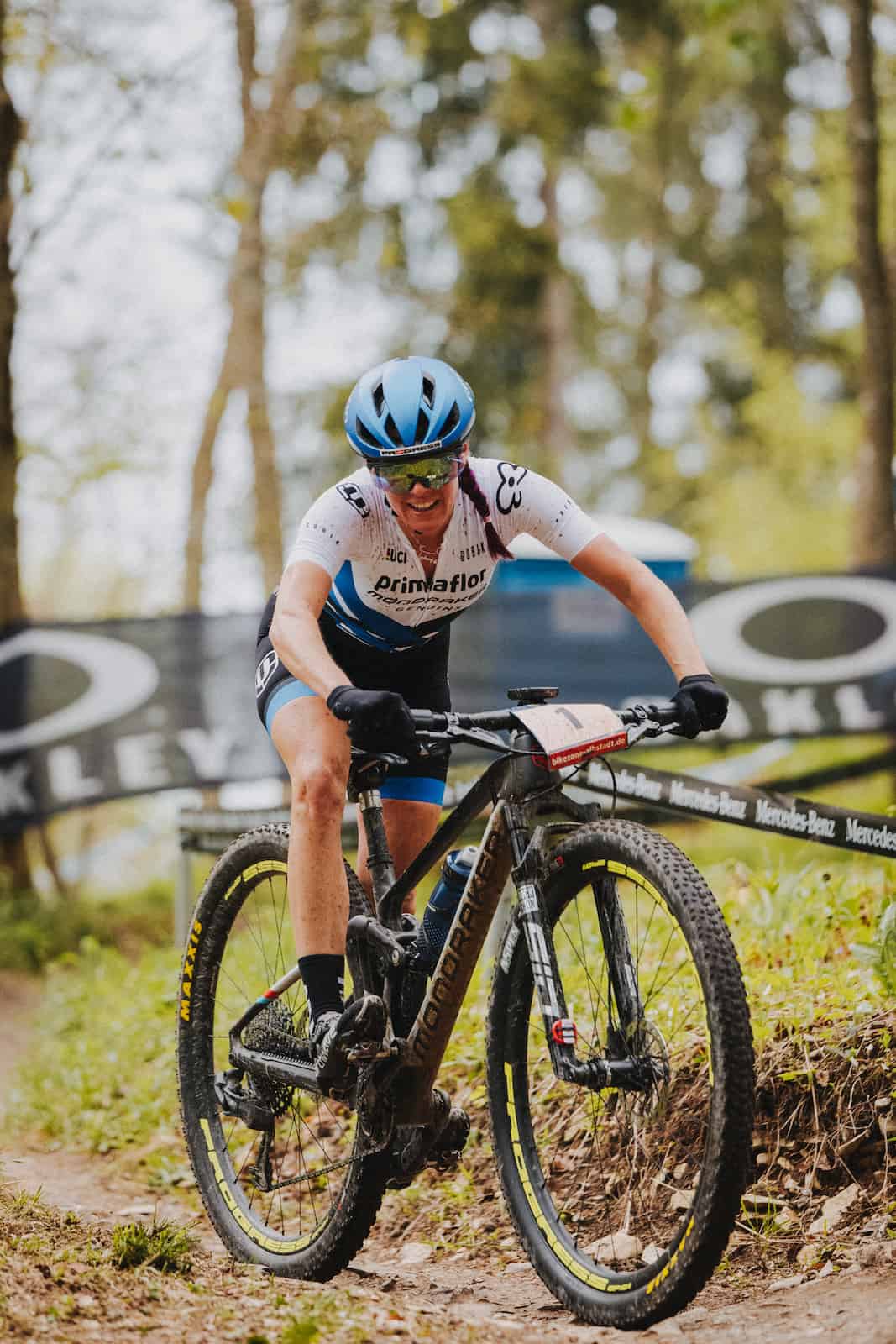Mountainbikerin bei einem Rennen im Wald, aufgenommen vom Eventfotografen Niklas Hesser