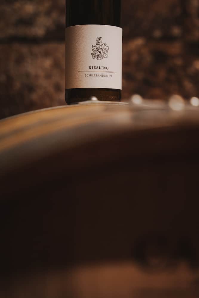 Weinflasche auf Holzfass in Erlenbach, fotografiert vom Eventfotografen Niklas Hesser