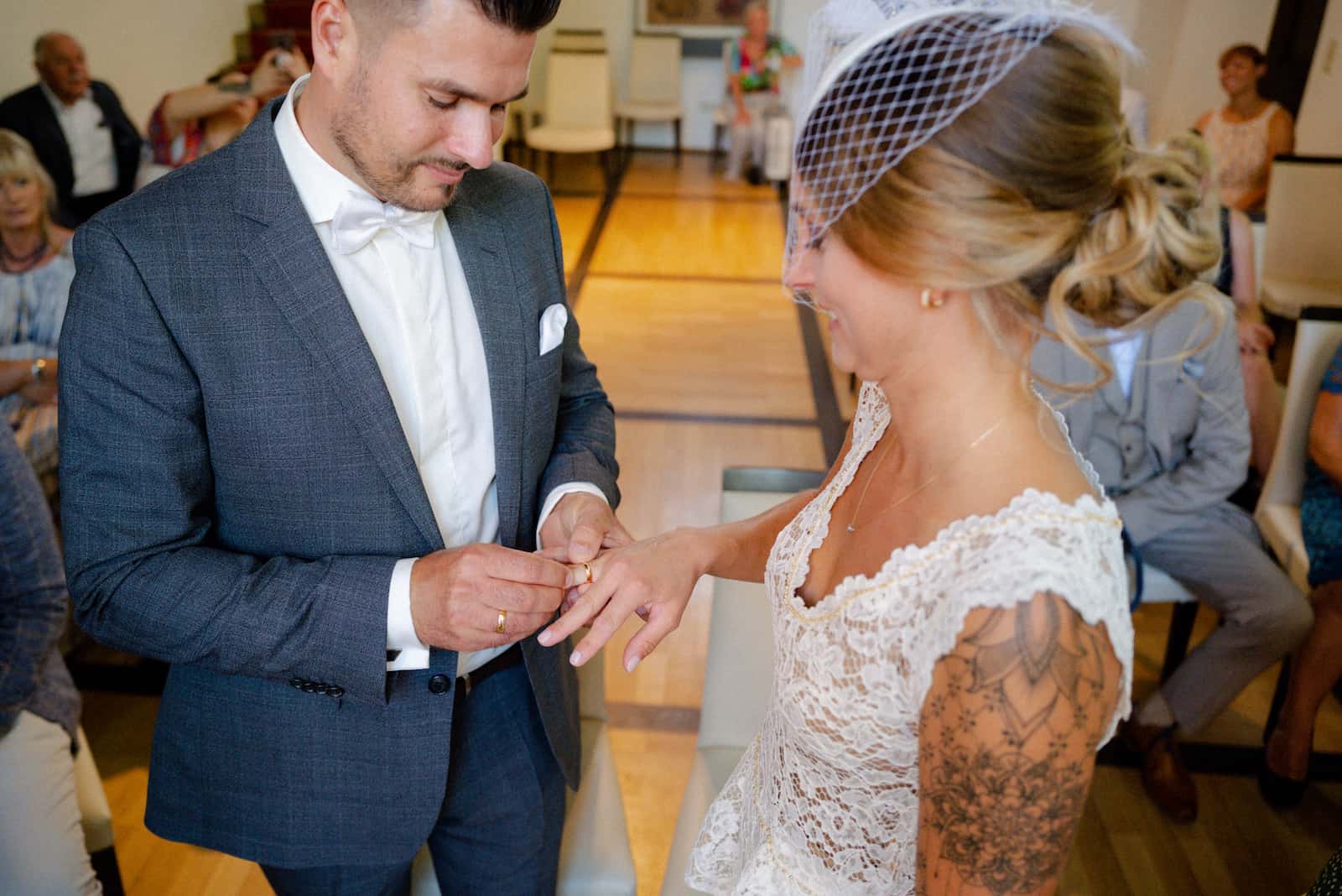 Standesamt Fotografie in Neckarsulm: Ein Paar tauscht Ringe während der Trauung.
