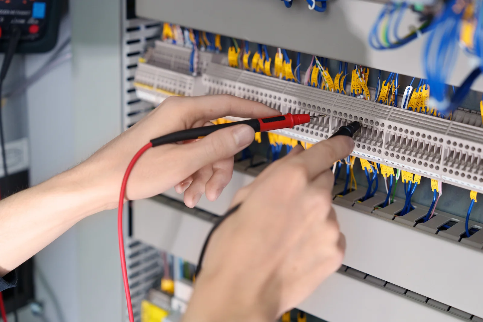 Businessfotografie in Heilbronn: Detailaufnahme eines Elektrikers bei der Arbeit an einem Schaltschrank